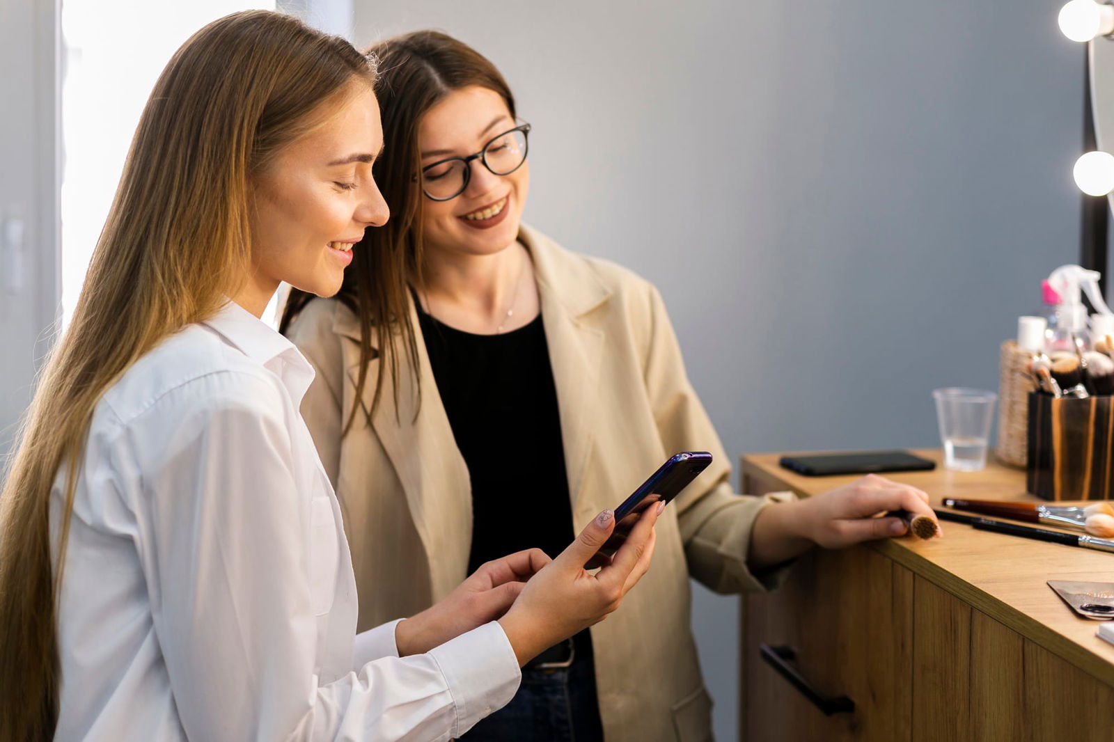 woman makeup artist looking phone